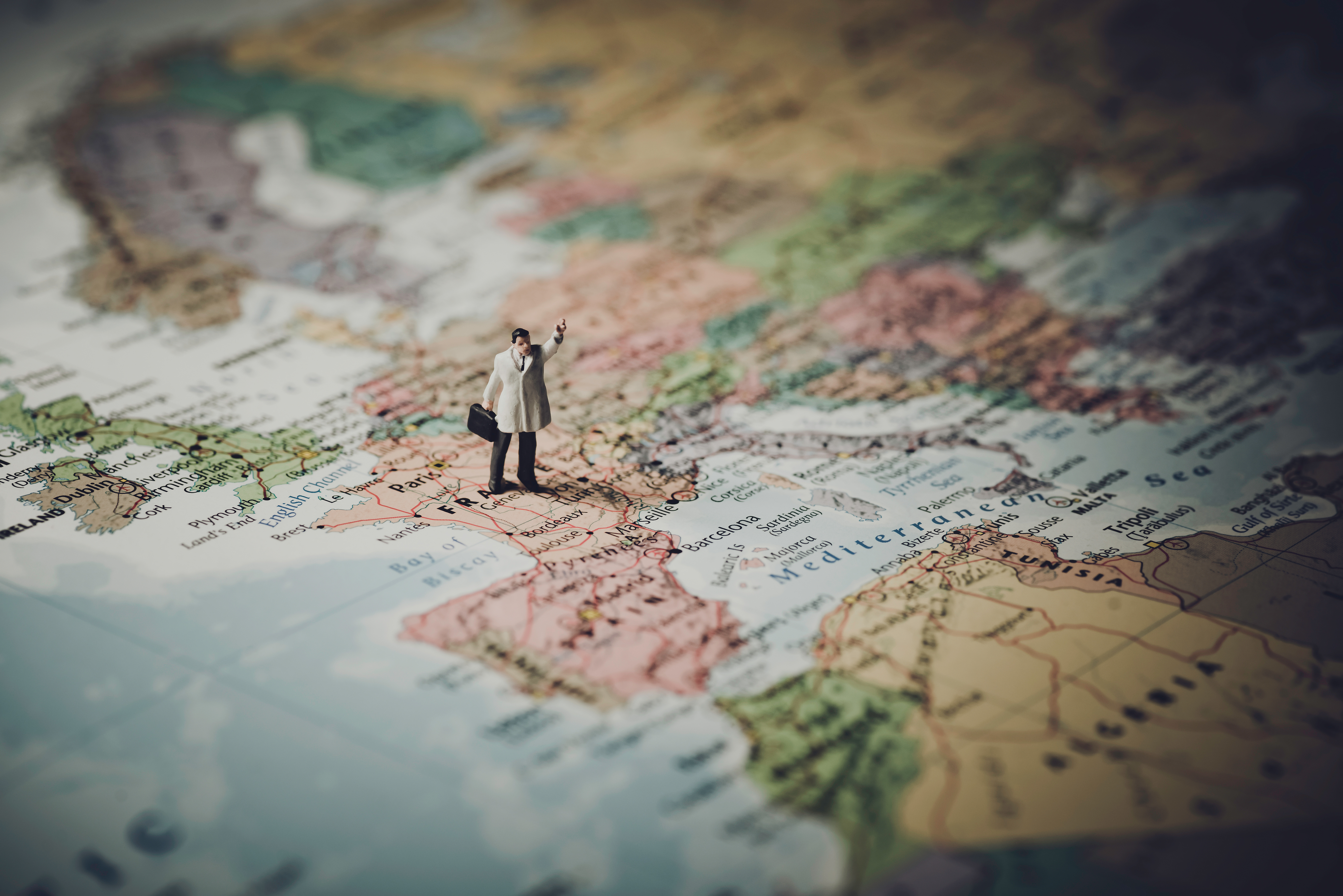 Miniature businessman on map of Europe.